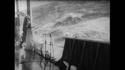 Atlantic Ocean, 1952: As the Flying Enterprise is 80 miles away from shore, strong waves crash onto the ship where Captain Carlsen stays Stock Footage