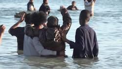 Migrants board a dinghy at Gravelines, France News Clip