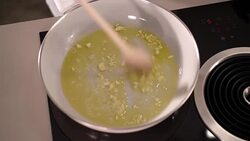 4K detail roasting garlic in pan Stock Footage