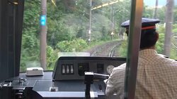 Hakone Tozan Mountain Train Passing Trough Small Stations, Tunnels And Winding Through A Narrow, Densely Wooded Valley In Hakone, Japan Stock Footage