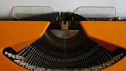 High and side angle footage of a person writing ISLAMOPHOBIA on a typewriter, with sound Stock Footage