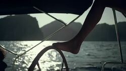 Woman steers the yacht with leg. Close-up Stock Footage