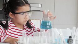 Education Topics:Funny little girl doing experiments in the laboratory.Science and education. Stock Footage