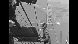 Construction workers build catwalk during construction of Golden Gate Bridge in San Francisco News Clip