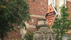 Liberal Democrat Party election campaign signs outside houses News Clip