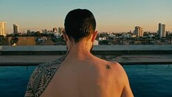 young man jumping to the rooftop pool above the city Stock Footage