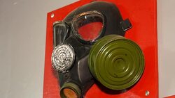 Old gas mask with a filter. The mask is fixed on the red stand. Memory of the accident at the Chernobyl nuclear power plant. Stock Footage