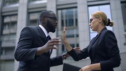 Boss shouting at office manager, woman shows stop gesture, employee rights Stock Footage
