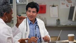 Male and female doctors consult with each other about a patient's case Stock Footage