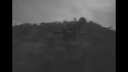 During Korean War, two South Korean soldiers running while under fire during Battle of Bloody Ridge in North Korea News Clip