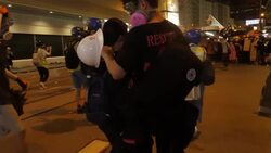 Riot police moving forwards banging batons News Clip