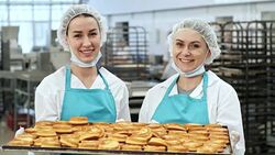 Smiling Women Holding Baking Tray Stock Footage