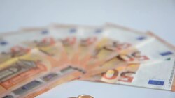 Tilt on Wedding rings and banknotes Stock Footage