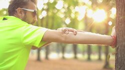 Man exercising / stretching in the park - nature. Stock Footage