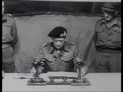 Germans surrender to Montgomery on Luneburger Heath. Montgomery speaks to camera. WWII Victory celebrations in Holland and England, Royals on balcony, King George's gives speech. Stock Footage