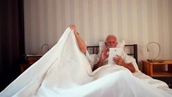 Senior woman suffering from back pain getting out of bed Stock Footage