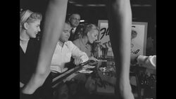 Men and women sit and sip Atomic Cocktails at bar in Flamingo Hotel in Las Vegas News Clip