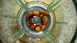 Crushing of almonds in the blender. Slow motion.	Knives crush almonds. Top view. Stock Footage