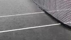 Raining on tennis court Stock Footage