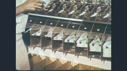 1960s: Close view of machine shows checks speed-sorted into chutes Stock Footage