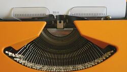 Close up footage of a person writing TERRORISM on an old typewriter, with sound Stock Footage