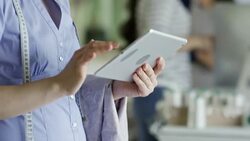 Asian Woman Working on Clothing Design Stock Footage