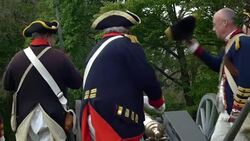 Revolutionary War artillery crew igniting cannon Stock Footage