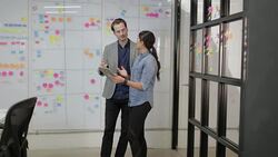 Coworkers in a late meeting working on schedule Stock Footage
