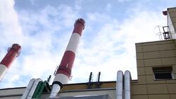 Smoking stack of the thermal power station against a blue sky. Smoking stacks of thermal power station. Stock Footage
