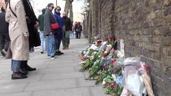 People bring flowers to the Russian embassy wall in London News Clip