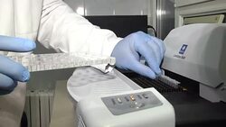 Microcentrifuge tubes in the thermocycler that ready to amplify gene, DNA or RNA fragment in molecular laboratory. Scientist holding PCR tube put into PCR machine Stock Footage