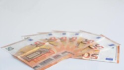 Tilt on Wedding rings and banknotes Stock Footage