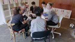 Creative designers meeting, discussing photograph proofs in circle Stock Footage