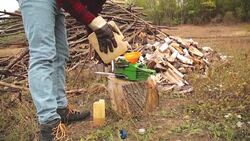 Lumberjack fixing / maintain the chainsaw outdoors. Stock Footage