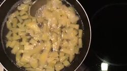 A chef in a professional kitchen cooking mashed potatoes in metal pan on rustic table background in the kitchen. Concept diet, food, Italian and nutrition. Stock Footage