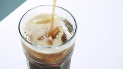 Pouring soft drink with Ice and bubbles in glass Stock Footage