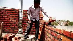 Bricklayer installing bricks on construction site Stock Footage