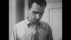 1950s: Husband looks over shoulder at closed door Stock Footage