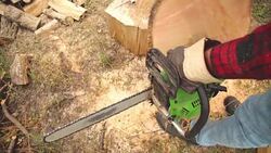 Lumberjack cutting woods with a chainsaw for winter. Stock Footage