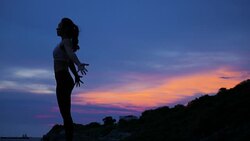 Silhouette young woman standing yoga pose on the beach at sunset, Sunrise background. Fitness, sport, yoga and healthy lifestyle concept. Stock Footage