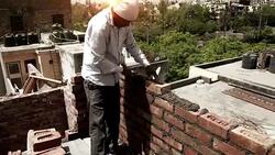 Bricklayer installing bricks on construction site Stock Footage