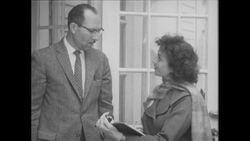 1960s: Woman speaks to resident, referencing her clipboard Stock Footage