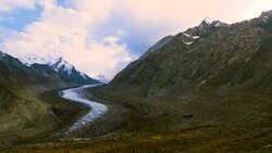 Beautiful landscpe of Drang-Drung Glacier with flowers, Mountain glacier on zanskar road at Himalaya Range, Zanskar Range, Pensi La, Jammu and Kashmir, Ladakh India. Stock Footage