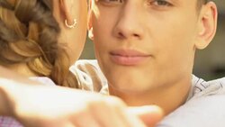Boy hugging girl and looking at camera, betrayal in relationship, face closeup Stock Footage