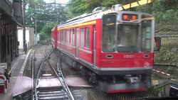 Hakone Tozan Mountain Train Passing Trough Small Stations, Tunnels And Winding Through A Narrow, Densely Wooded Valley In Hakone, Japan Stock Footage