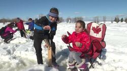 Syrian refugees learn how to ice fish News Clip