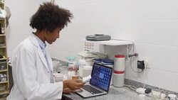 Chemist analyzing prescription while using laptop Stock Footage