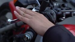 female hand pressing lever arm motorcycle clutch for start Stock Footage