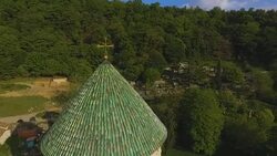 Bagrati Cathedral rooftops surrounded by Caucasus mountain, amazing landscape Stock Footage