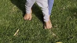 Barefoot parent teaching little son to walk on feet Stock Footage
